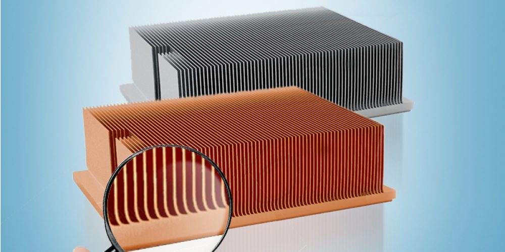 Two ecotherm custom skived heatsinks, one made of pure copper and one made of aluminum, with a magnifying glass at the front showing the fin details